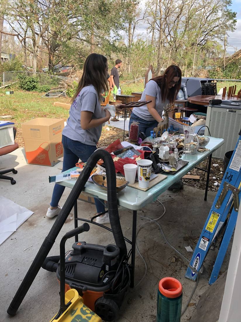 Magnolia team cleaning household contents at a work table