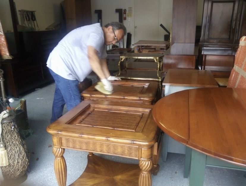 Magnolia technician hand-cleaning wood furniture