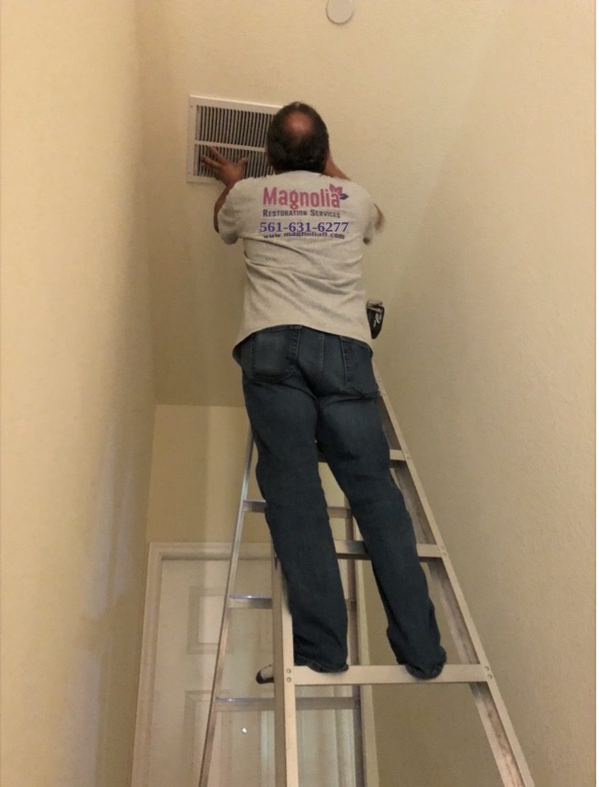 Magnolia technician cleaning an air vent after smoke damage