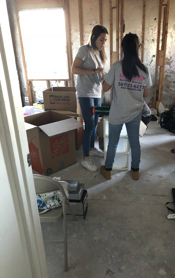 Magnolia team wrapping furniture inside a home under repair