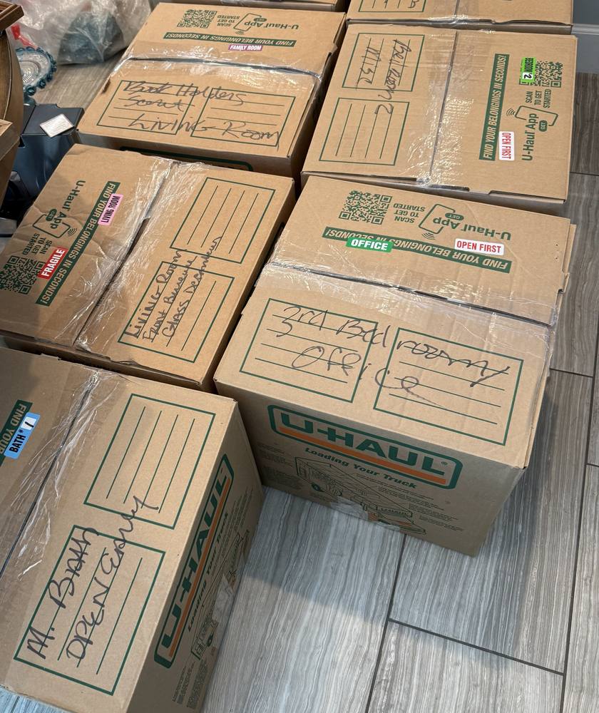 Boxes labeled by room and contents during a pack-out